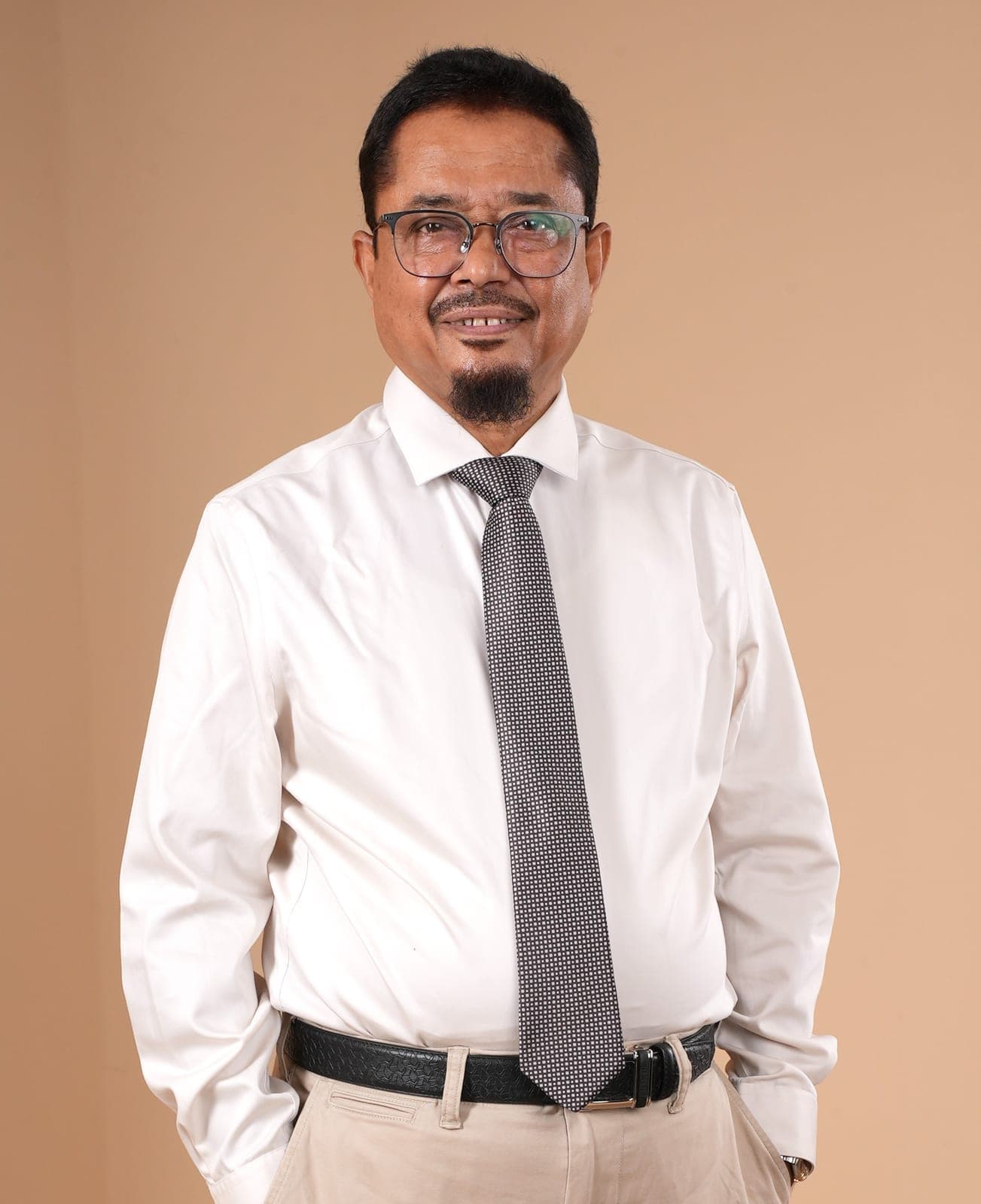 Dr. Noor Mohammed Badie in a corporate leadership setting.